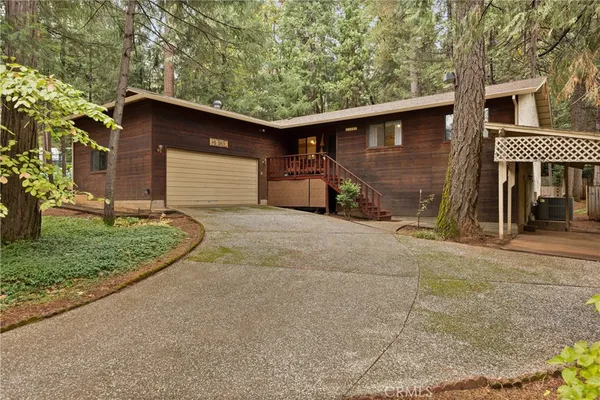 a view of a house with a yard and garage