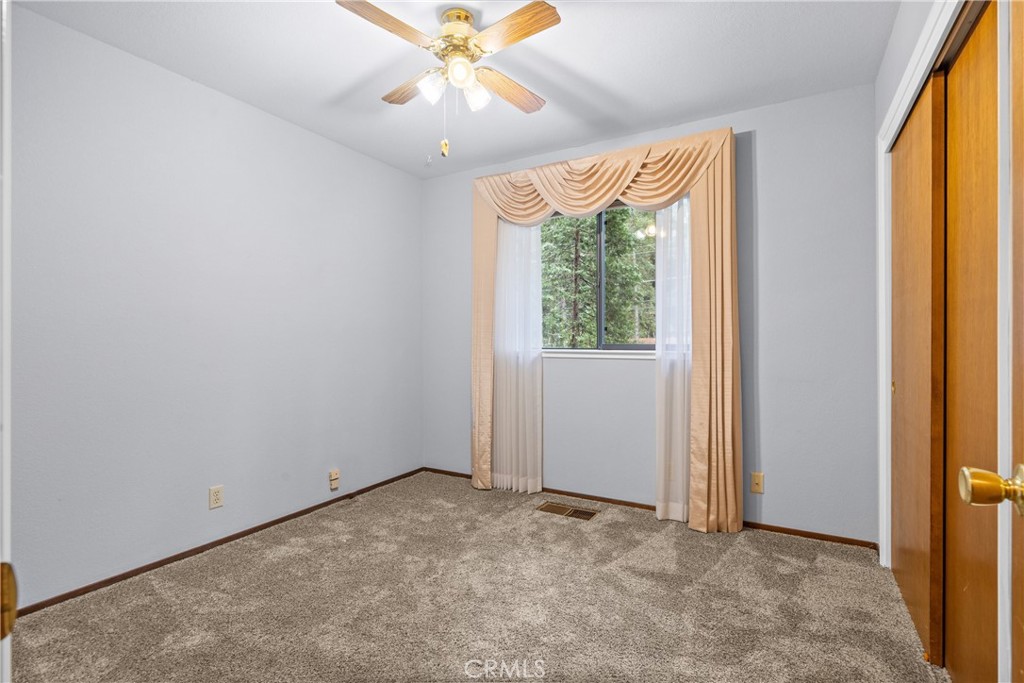 14405 Clarion Way Magalia, CA 95954 - Photo 13 of 25 an empty room with a window and a fan