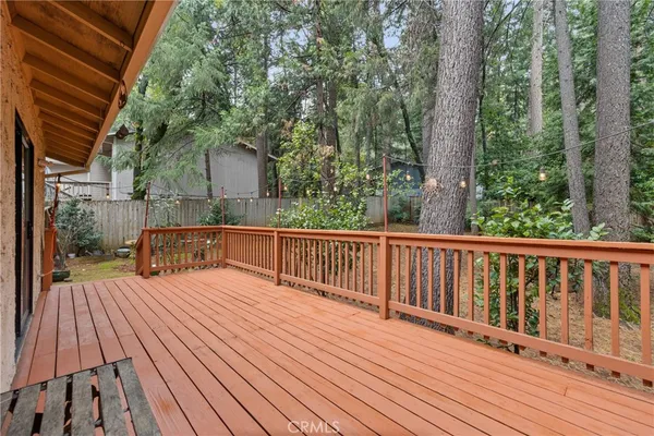 a balcony with wooden floor and fence
