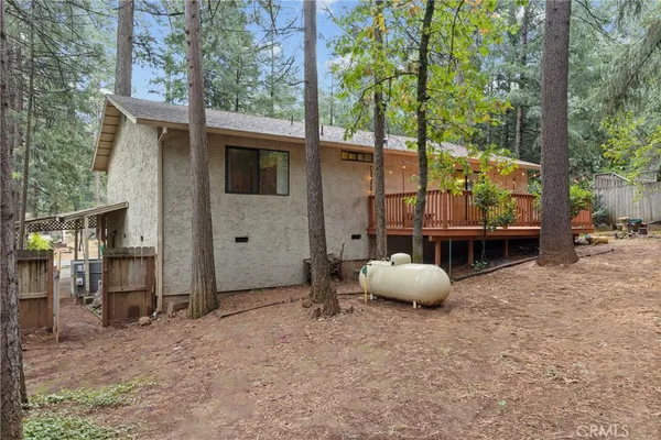 a backyard of a house with table and chairs
