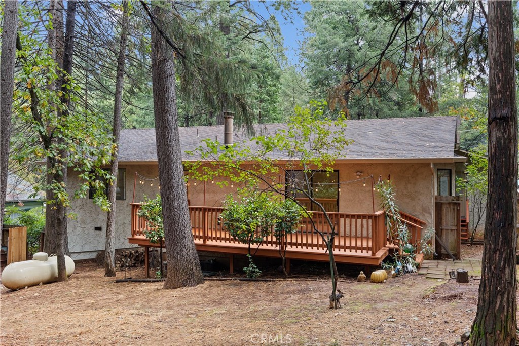 14405 Clarion Way Magalia, CA 95954 - Photo 22 of 25 a view of a roof deck with table and chairs and wooden fence