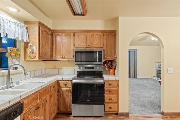 a kitchen with stainless steel appliances a stove and a sink