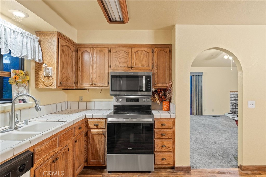 14405 Clarion Way Magalia, CA 95954 - Photo 7 of 25 a kitchen with stainless steel appliances a stove and a sink