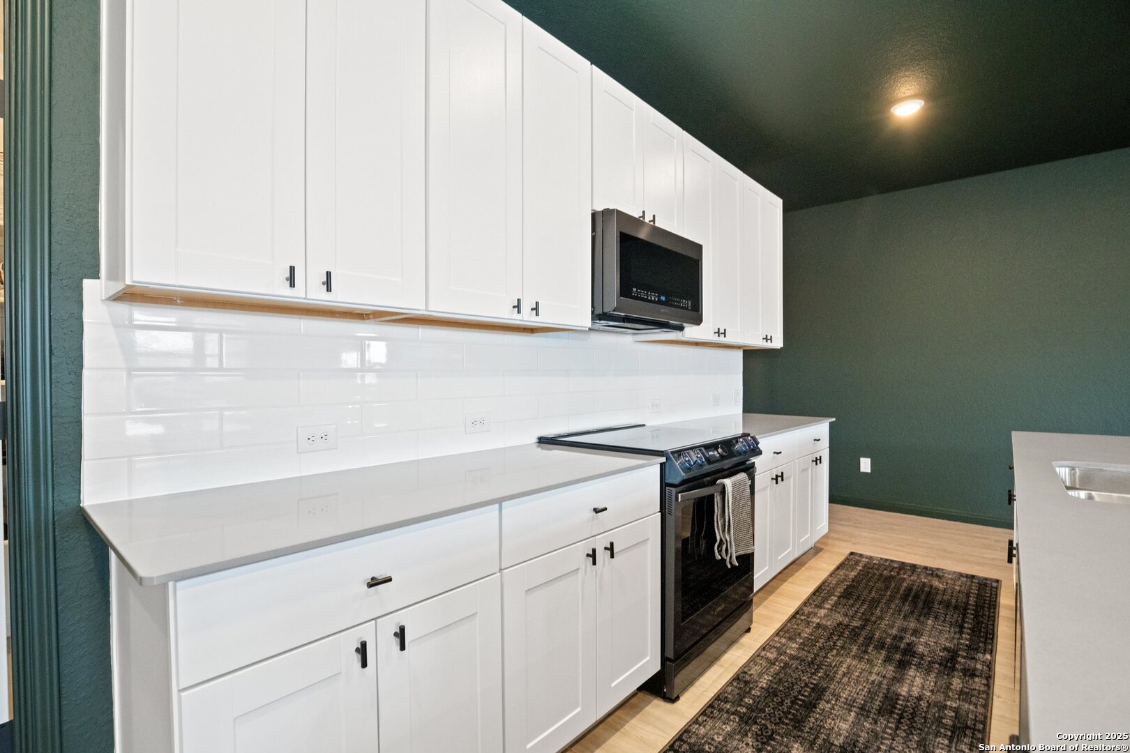 808 Riviera Court Seguin, TX 78155 - Photo 6 of 22 a kitchen with stainless steel appliances granite countertop a sink and a stove