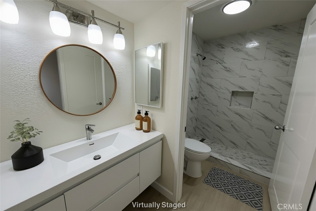 435 South Virgil Avenue, Unit 209 Los Angeles, CA 90020 - Photo 11 of 31 a bathroom with a toilet sink and mirror