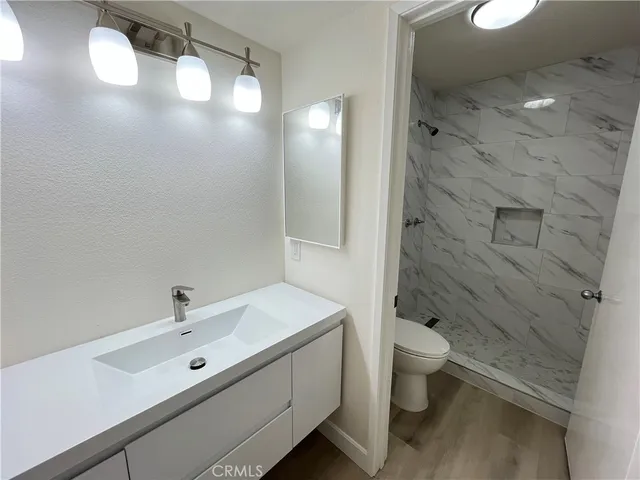 a bathroom with a double vanity sink toilet and shower