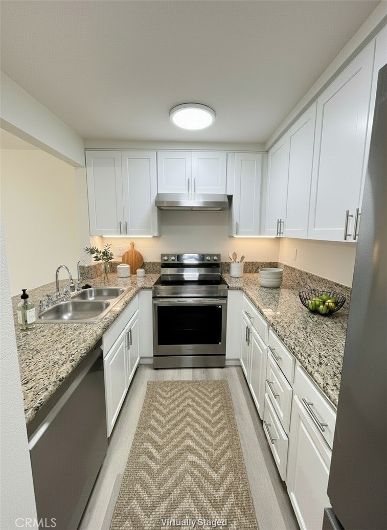 435 South Virgil Avenue, Unit 209 Los Angeles, CA 90020 - Photo 14 of 31 a kitchen with granite countertop stainless steel appliances a stove a sink and a counter space