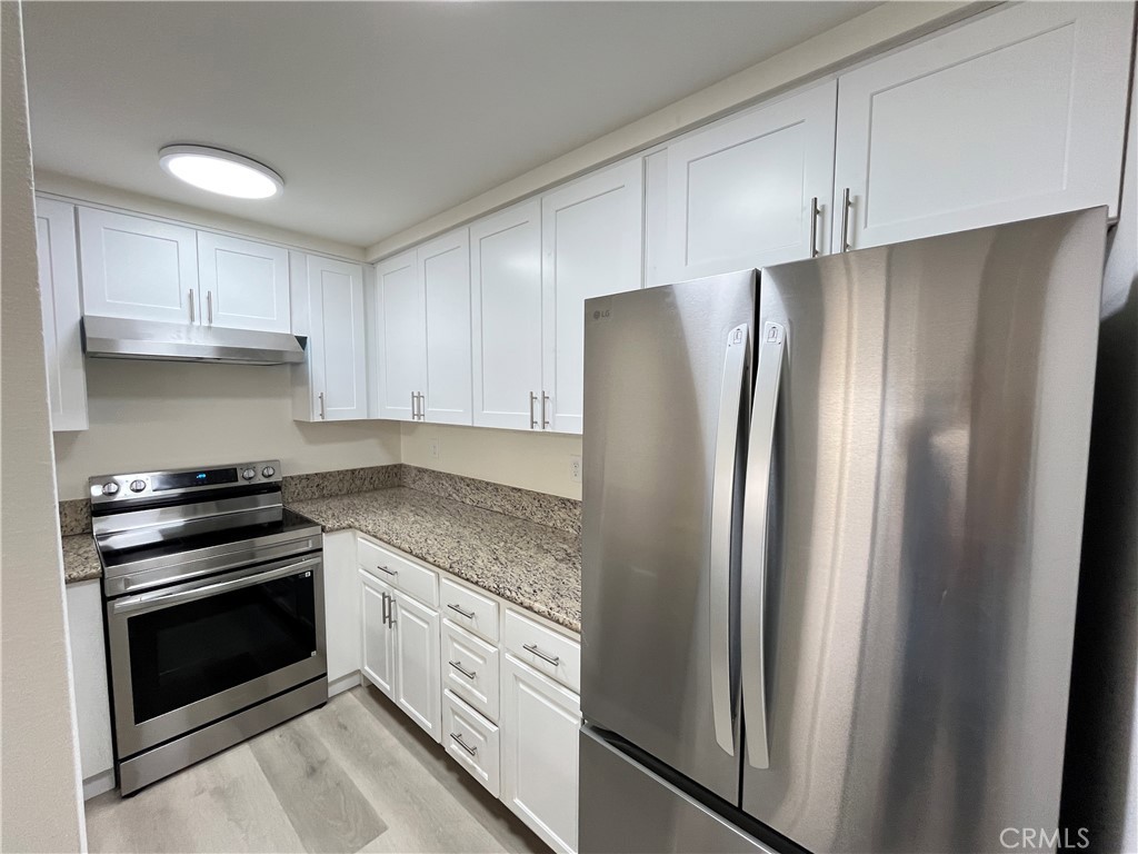 435 South Virgil Avenue, Unit 209 Los Angeles, CA 90020 - Photo 15 of 31 a kitchen with stainless steel appliances granite countertop a refrigerator and a stove top oven