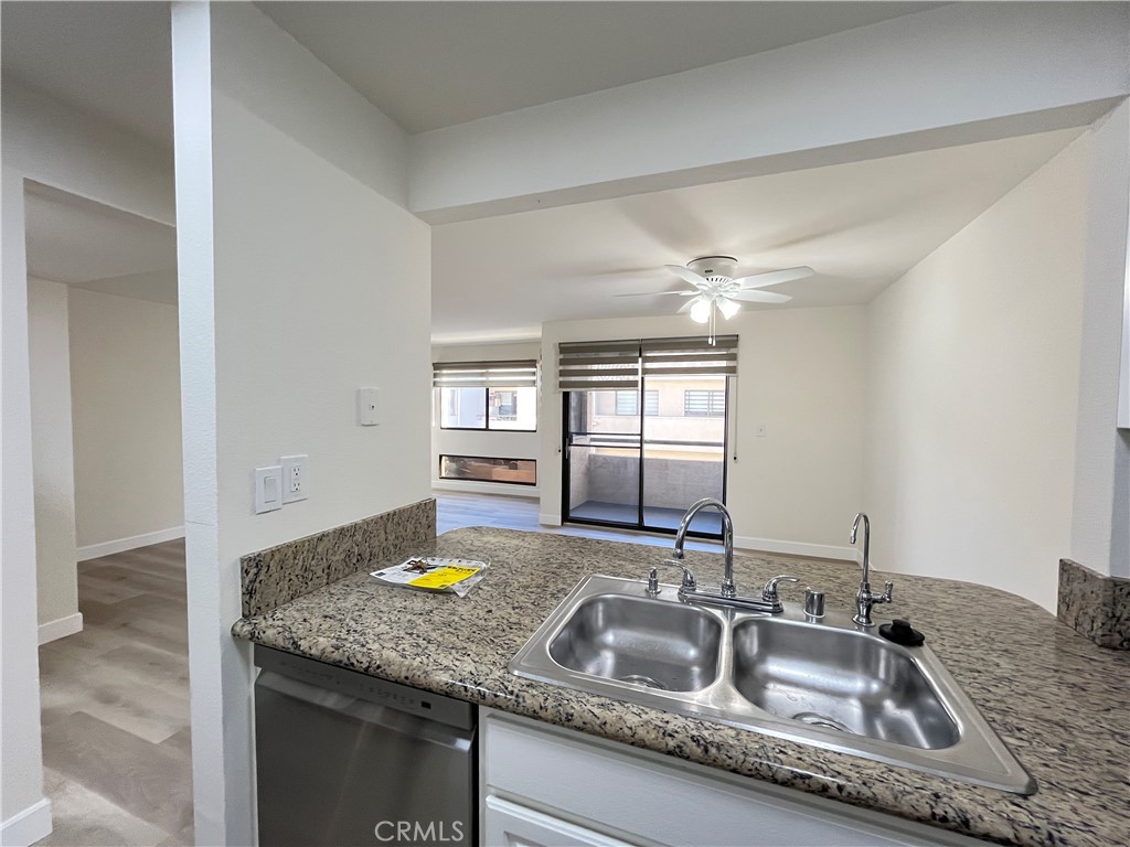 435 South Virgil Avenue, Unit 209 Los Angeles, CA 90020 - Photo 17 of 31 a kitchen with granite countertop a sink and a wooden floor
