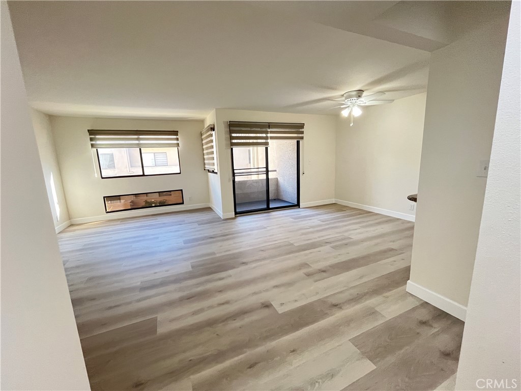 435 South Virgil Avenue, Unit 209 Los Angeles, CA 90020 - Photo 2 of 31 a view of an empty room with a window and wooden floor