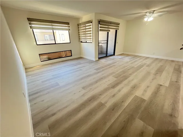a living room with a bed furniture and a window