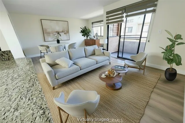 a living room with furniture and a floor to ceiling window