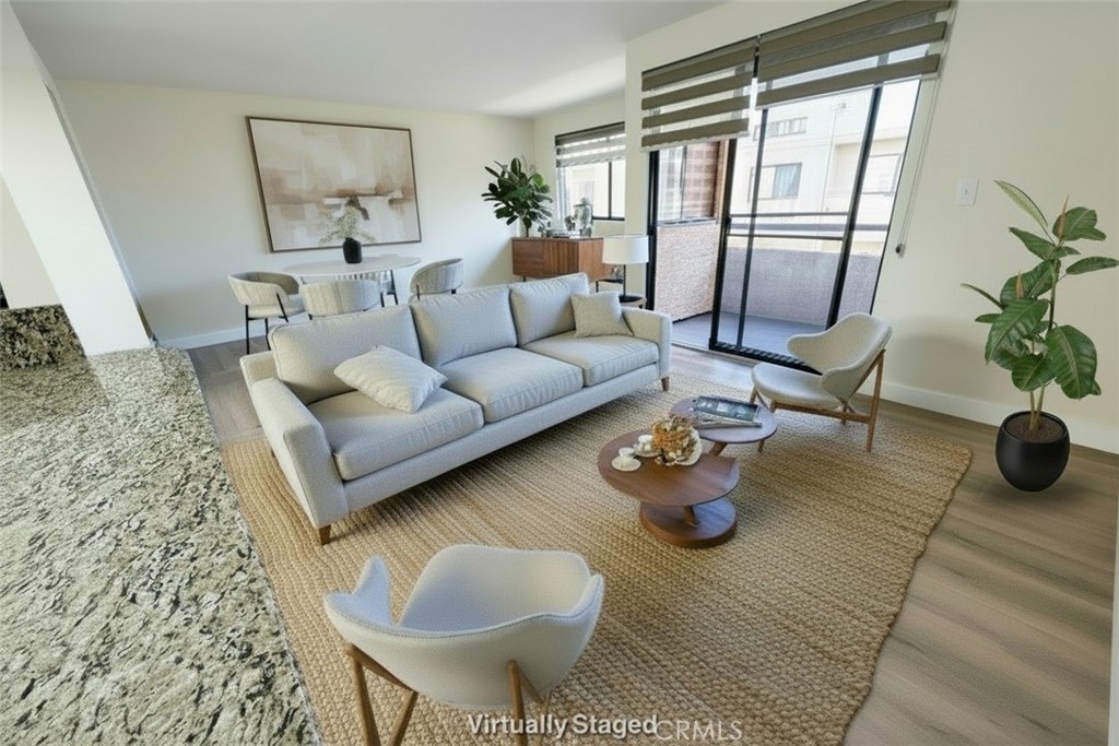 435 South Virgil Avenue, Unit 209 Los Angeles, CA 90020 - Photo 6 of 31 a living room with furniture and a floor to ceiling window