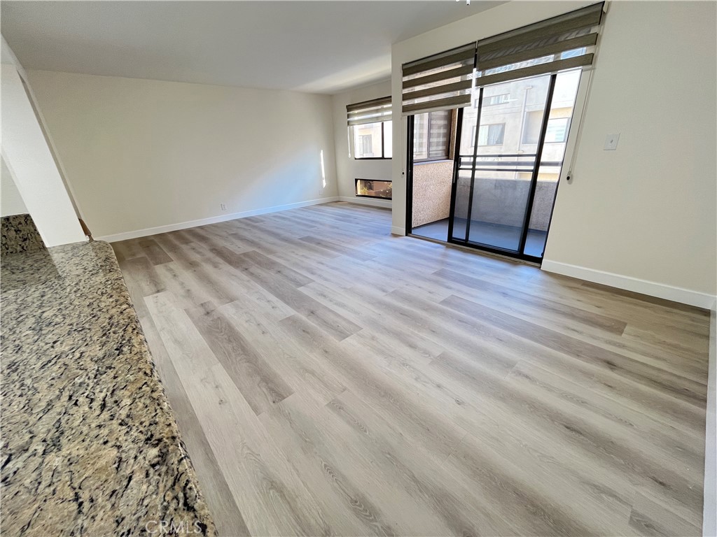 435 South Virgil Avenue, Unit 209 Los Angeles, CA 90020 - Photo 7 of 31 a view of empty room with wooden floor and fan