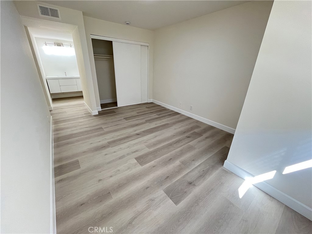 435 South Virgil Avenue, Unit 209 Los Angeles, CA 90020 - Photo 8 of 31 an empty room with wooden floor and entrance