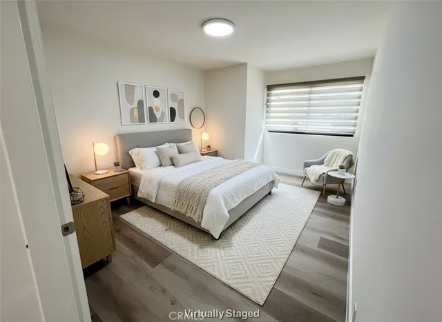 a bedroom with a bed and wooden floor