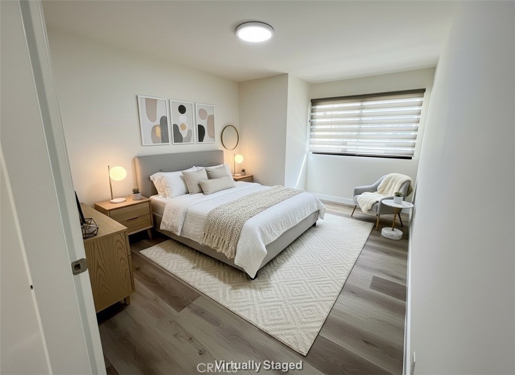 435 South Virgil Avenue, Unit 209 Los Angeles, CA 90020 - Photo 9 of 31 a bedroom with a bed and wooden floor