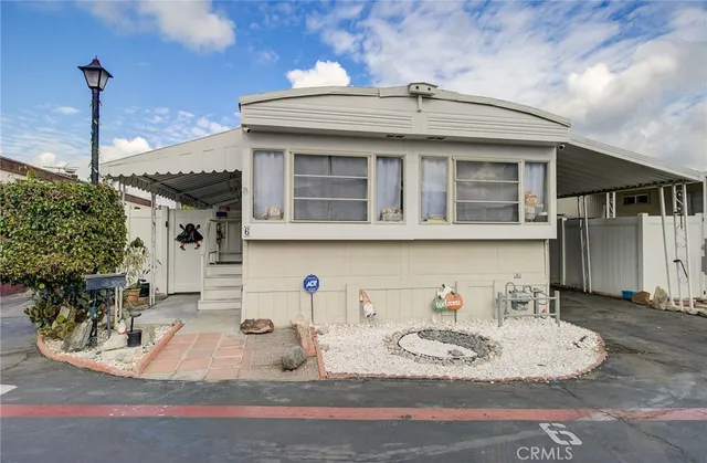 a view of a white house with table and chairs