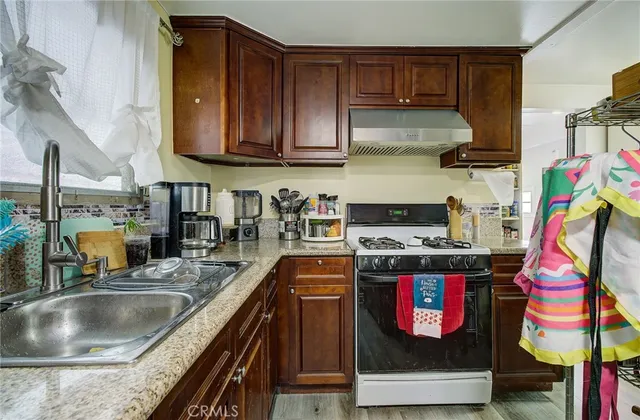 a kitchen with stainless steel appliances granite countertop a stove and cabinets