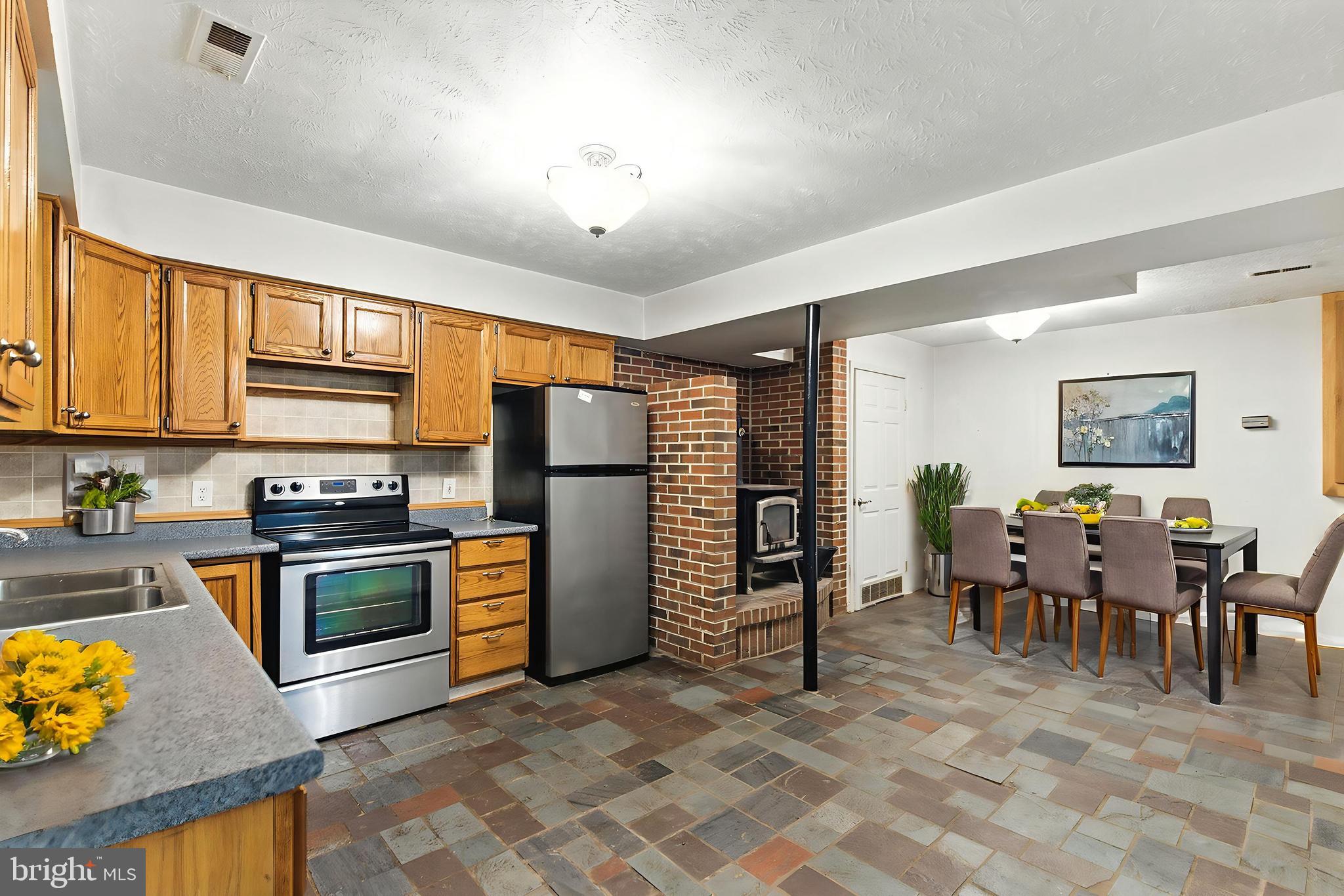106 Inca Road Linden, VA 22642 - Photo 3 of 17 a open kitchen with stainless steel appliances granite countertop a stove refrigerator and cabinets