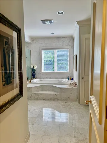 a room with a large window and furniture