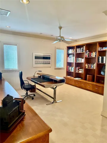 a view of a hallway and a livingroom with furniture