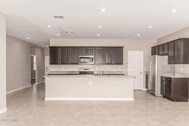 a large kitchen with stainless steel appliances lots of counter top space cabinets and stainless steel appliances