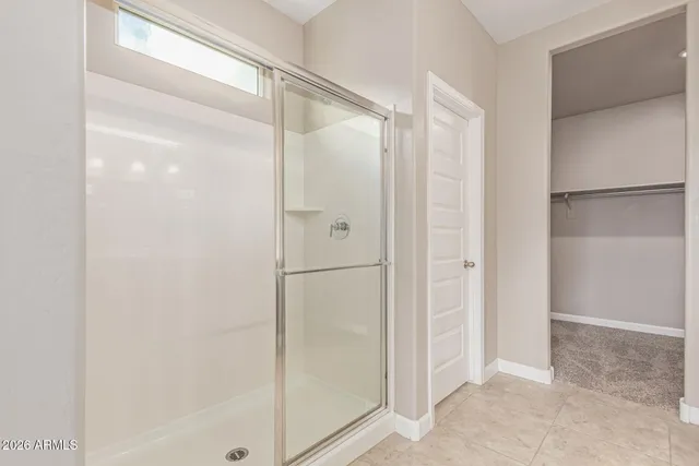 a bathroom with a glass shower door