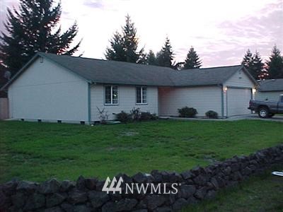 5405 187th Court Southwest Rochester, WA 98579 - Photo 1 of 1 a backyard of a house with table and chairs