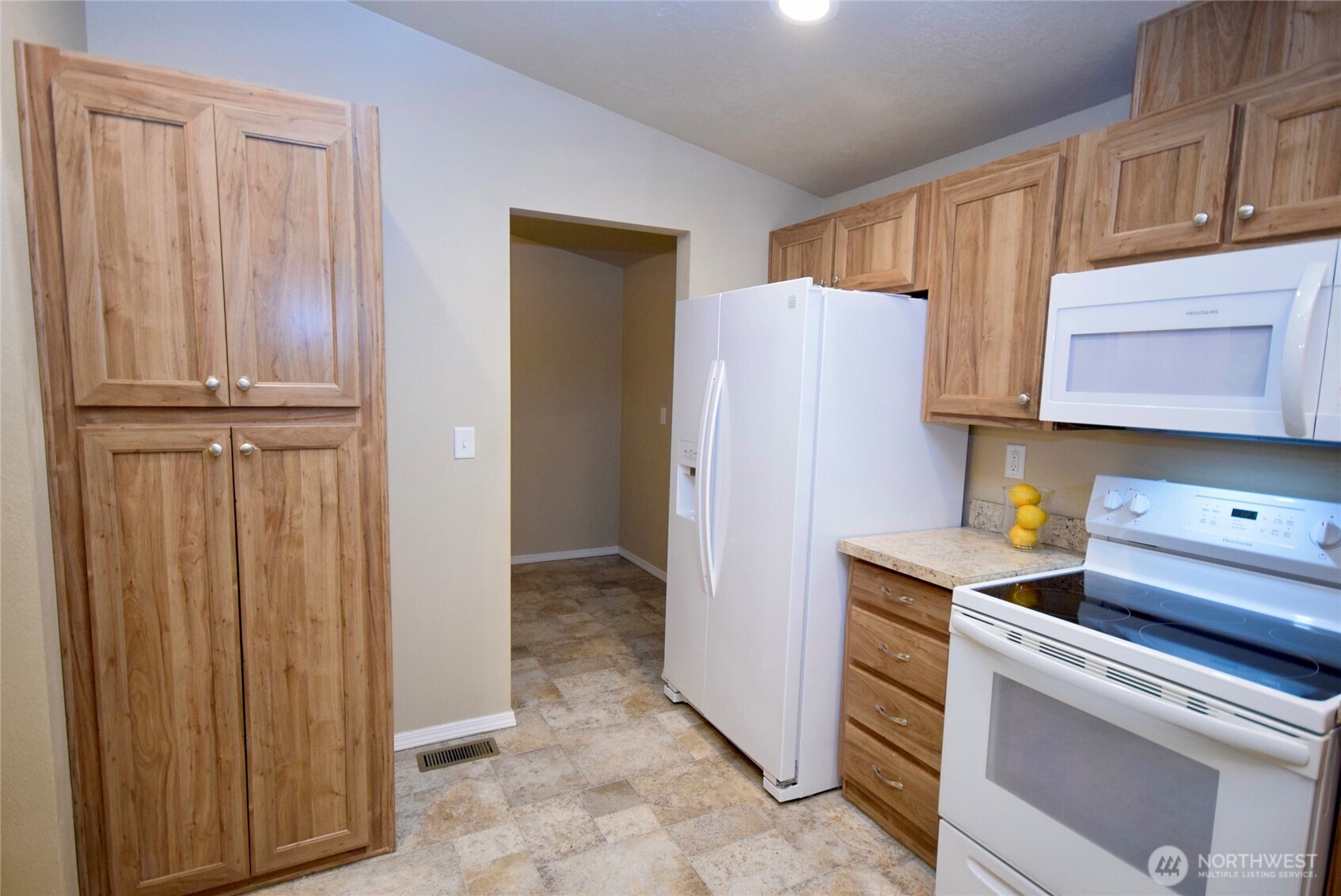 375 Dungeness Meadows Sequim, WA 98382 - Photo 12 of 27 a kitchen with a refrigerator and cabinets