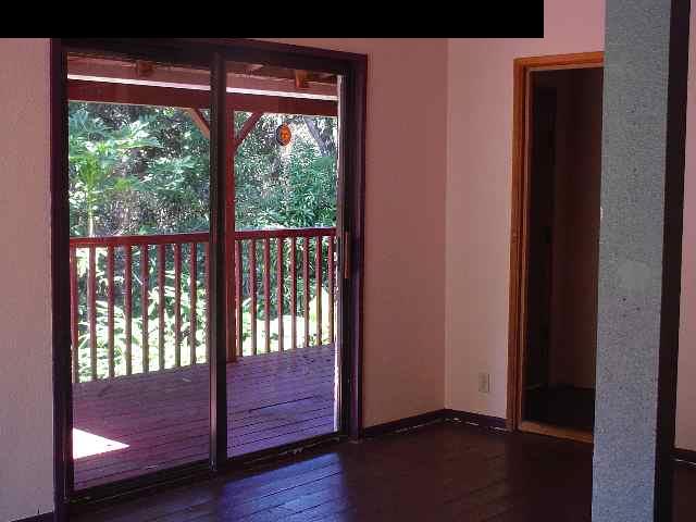 497 Kawelo Road Haiku, HI 96708 - Photo 12 of 18 a view of empty room with wooden floor and fan