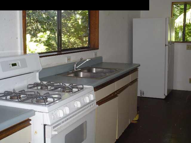 497 Kawelo Road Haiku, HI 96708 - Photo 15 of 18 a kitchen with a stove and a window