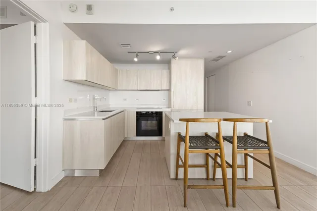 a kitchen with a table chairs and a refrigerator