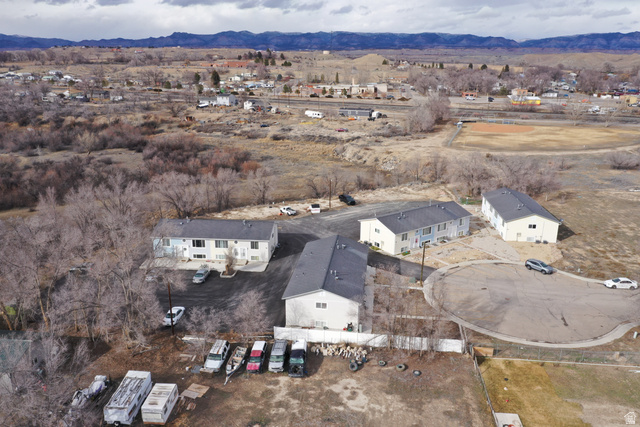 102 East Richelman Lane Wellington, UT 84542 - Photo 4 of 39 Aerial overview of property's location with mountains and nearby suburban area