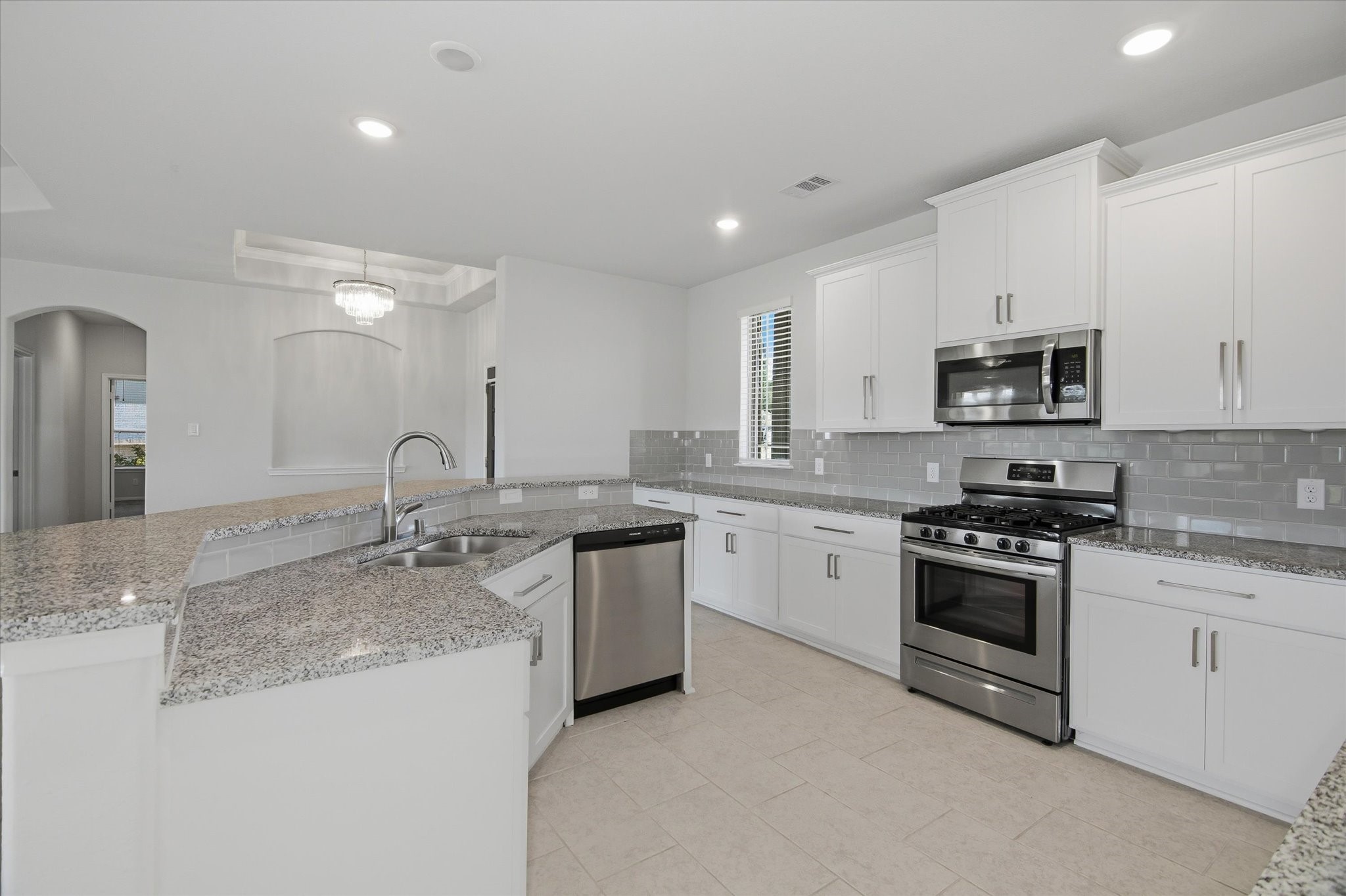 16738 Rockwall Street Conroe, TX 77303 - Photo 11 of 42 The kitchen is a true centerpiece, balancing style and practicality with effortless charm. Granite countertops provide generous prep space and is beautifully paired with crisp white cabinetry that adds a clean, timeless appeal.