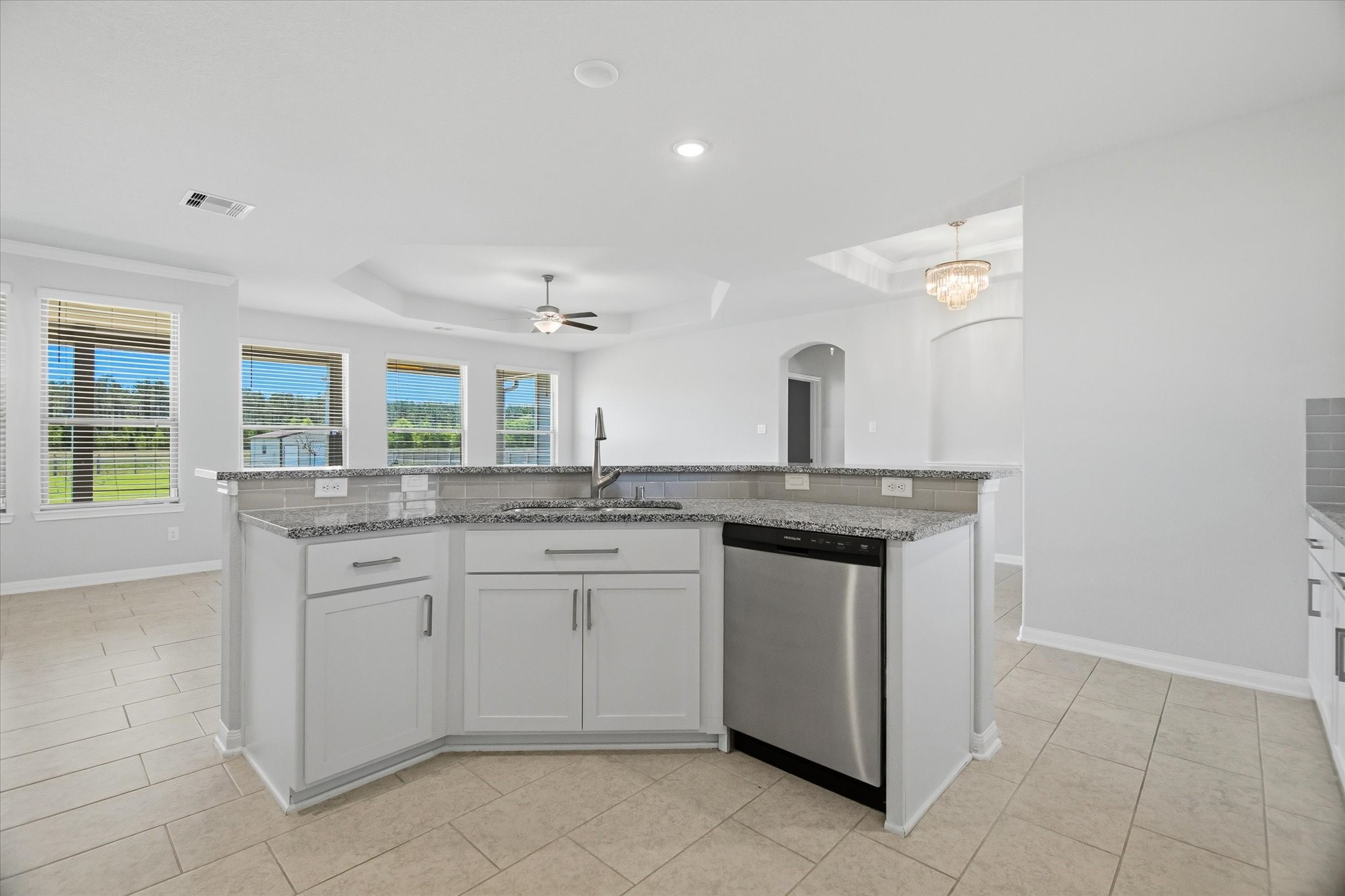 16738 Rockwall Street Conroe, TX 77303 - Photo 12 of 42 The oversized breakfast bar sets the stage for casual dining and easy conversation, naturally drawing people together. From there, the kitchen opens into the family room, creating a space that feels airy, welcoming, and perfectly suited for gathering.