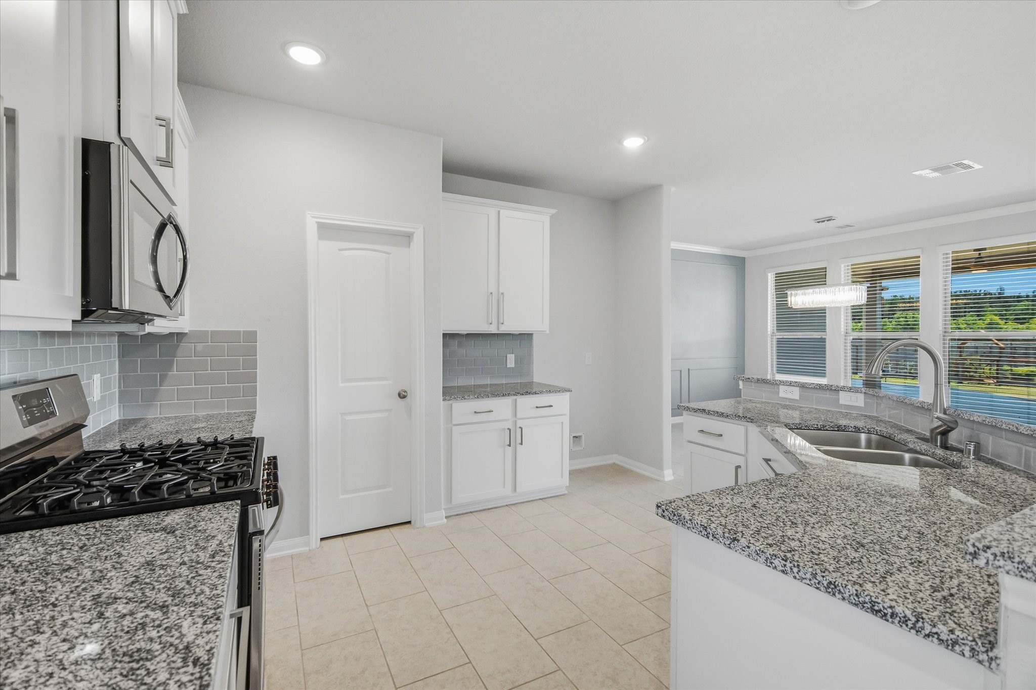 16738 Rockwall Street Conroe, TX 77303 - Photo 13 of 42 The backyard views become part of the kitchen's everyday backdrop, adding a sense of depth and calm to the entire space.