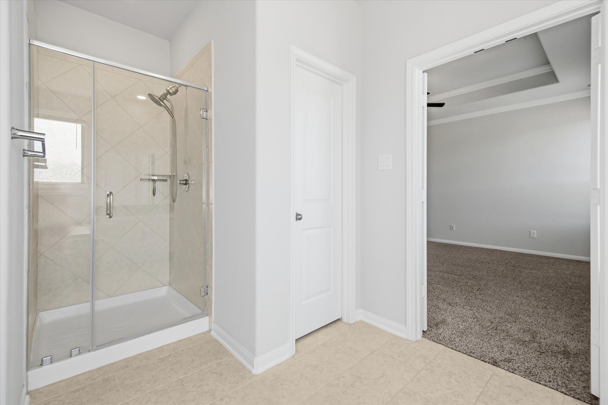 16738 Rockwall Street Conroe, TX 77303 - Photo 19 of 42 The large glass walk-in shower with rubbed nickel fixtures offers a sleek, modern touch.