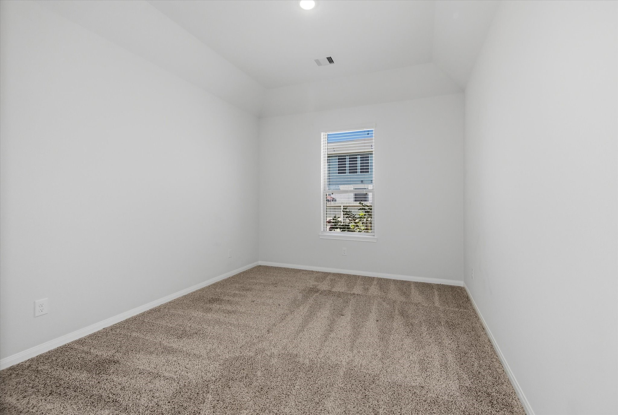 16738 Rockwall Street Conroe, TX 77303 - Photo 21 of 42 The home office offers a quiet place to focus or create. A vaulted ceiling enhances the sense of space, while natural light keeps the room bright and energizing. This could serve as a 4th bedroom.