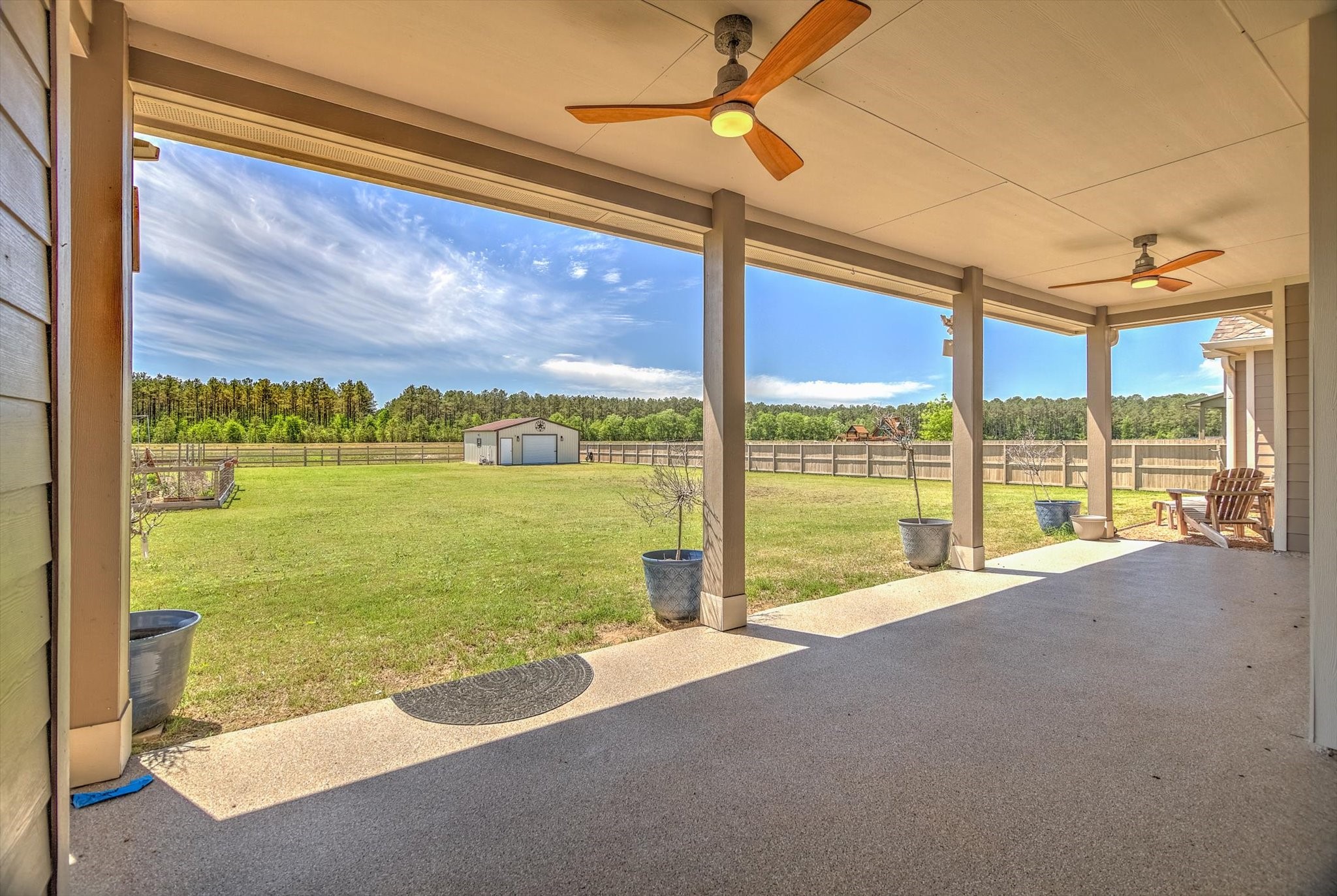 16738 Rockwall Street Conroe, TX 77303 - Photo 31 of 42 An extended covered patio with dual ceiling fans creates a comfortable setting for relaxing or hosting gatherings.