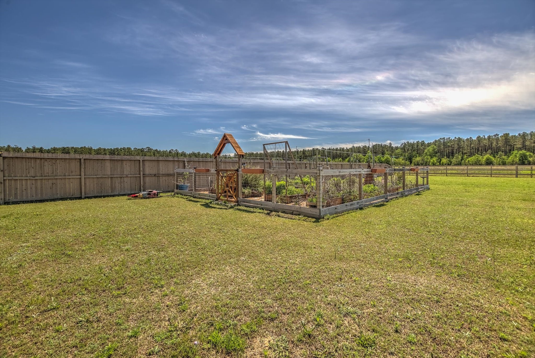 16738 Rockwall Street Conroe, TX 77303 - Photo 35 of 42 The existing farm patch adds a charming, down-to-earth touch, perfect for growing your own produce, creating a garden retreat, or simply enjoying a little slice of country living right at home.