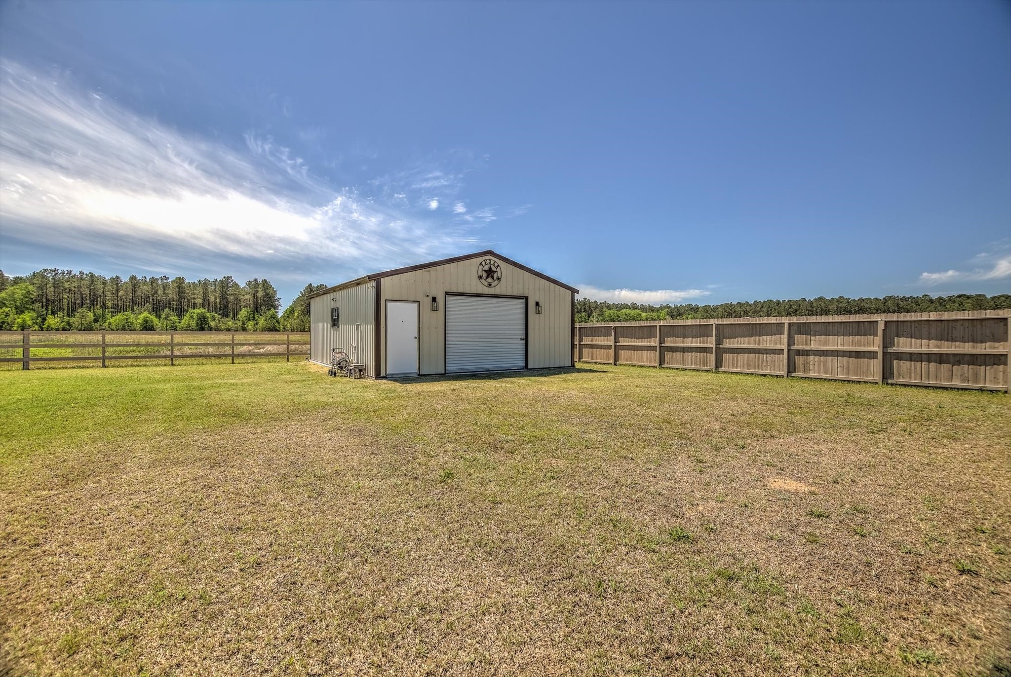 16738 Rockwall Street Conroe, TX 77303 - Photo 36 of 42 The 30x24 metal workshop is a standout feature, ready to support hobbies, projects, or additional storage. Fully equipped with insulation, power, air conditioning, and water, it’s a versatile space that adapts to your needs.