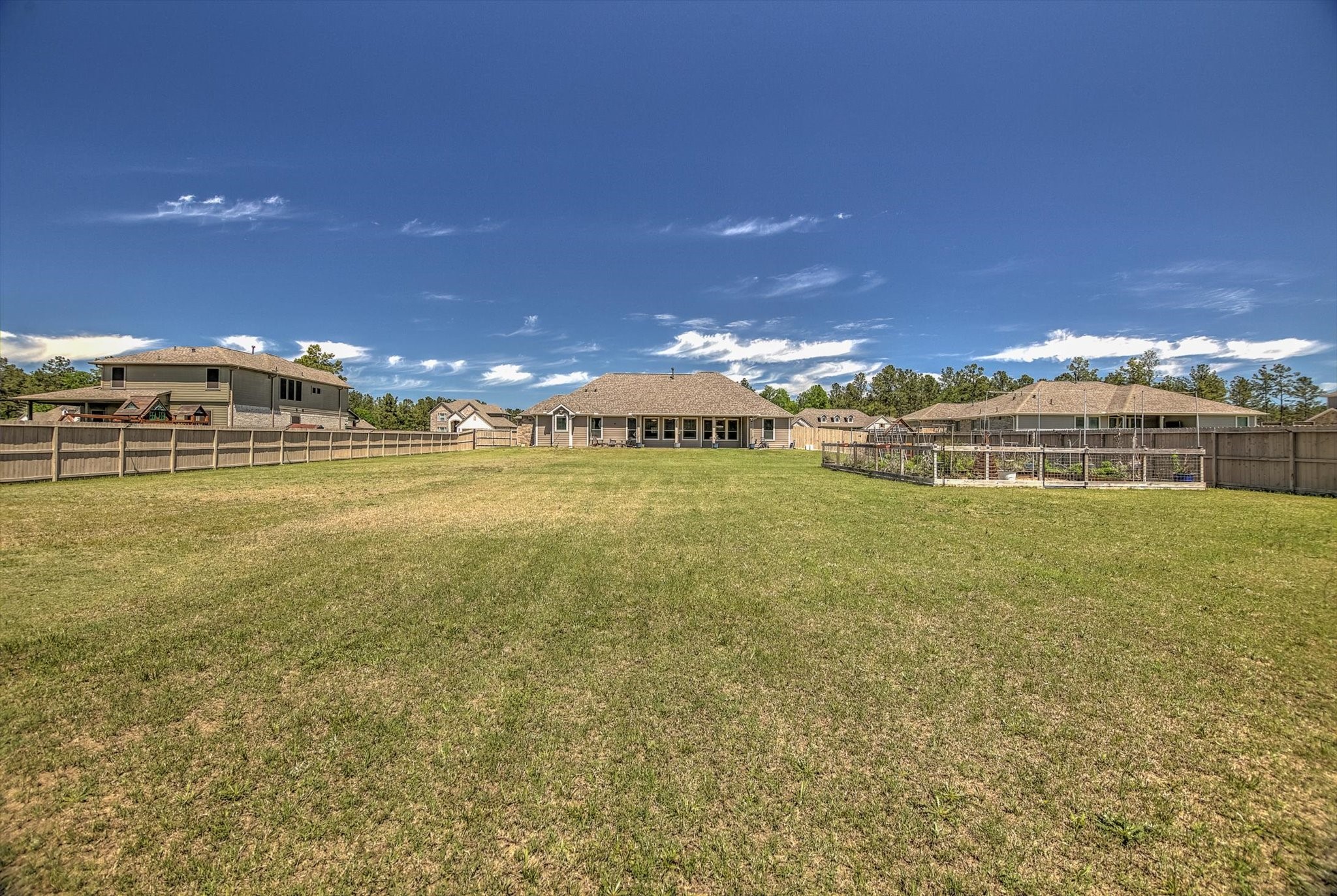 16738 Rockwall Street Conroe, TX 77303 - Photo 38 of 42 Picture a custom pool glistening under the Texas sun, an outdoor kitchen ready for weekend cookouts, and plenty of green space left to play, relax, or entertain.