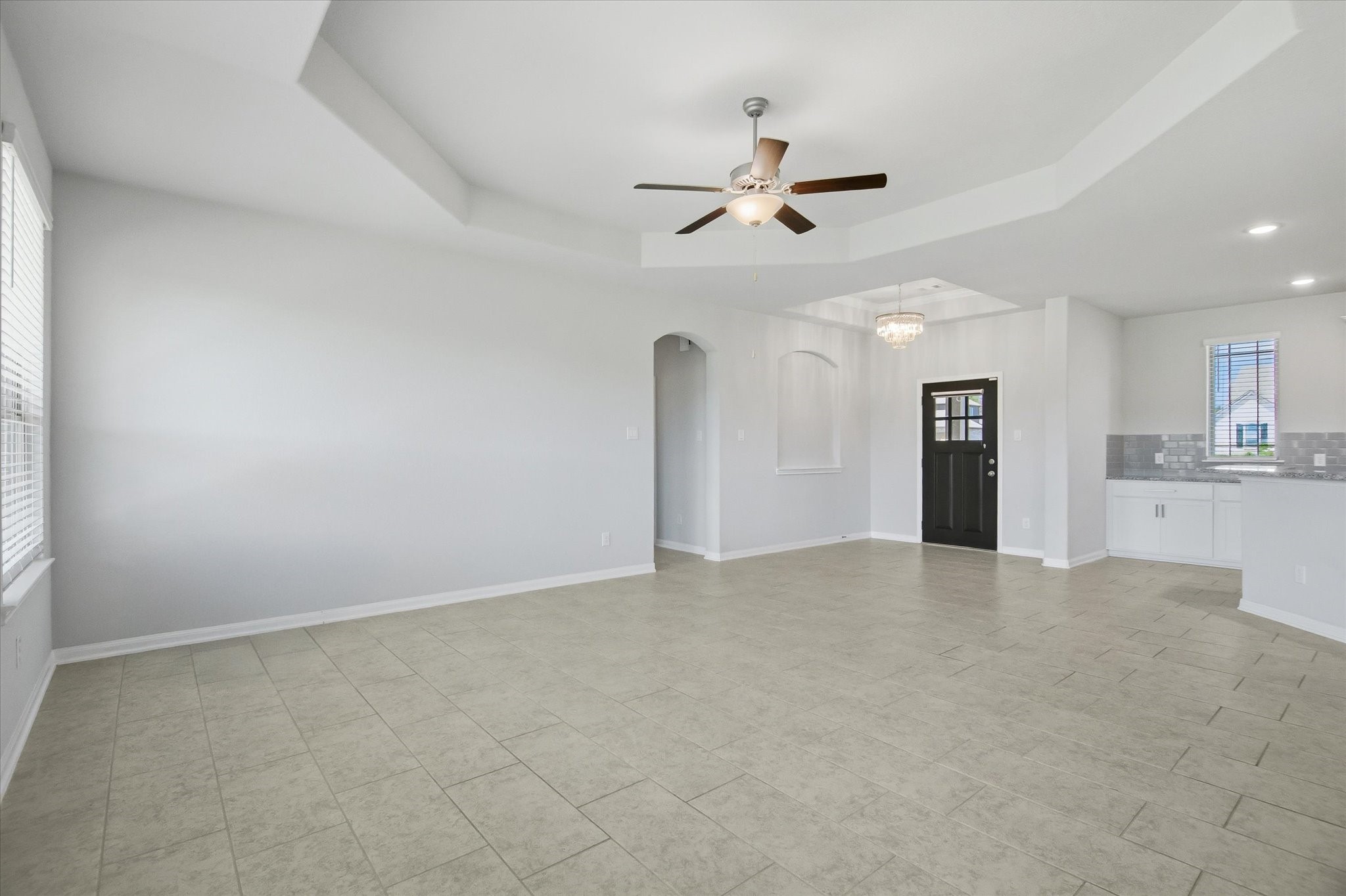 16738 Rockwall Street Conroe, TX 77303 - Photo 8 of 42 A dramatic tray ceiling adds dimension overhead, while a wall of windows floods the space with natural light and frames peaceful backyard views.