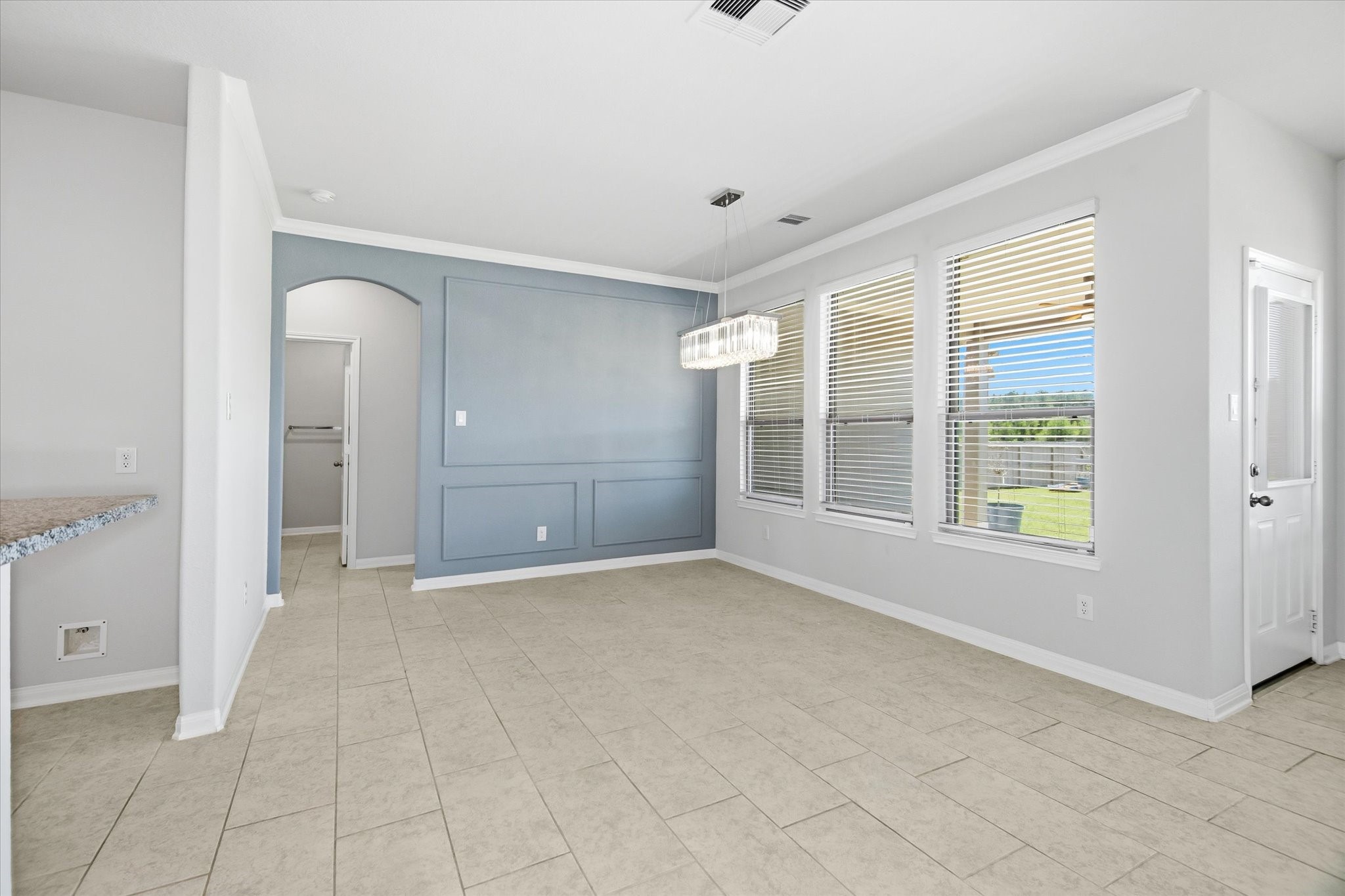 16738 Rockwall Street Conroe, TX 77303 - Photo 9 of 42 Just off the kitchen, the dining room feels like a sunlit escape within the home. An expansive window backdrop brings the outdoors in, creating a cheerful setting for morning coffee or evening dinners.