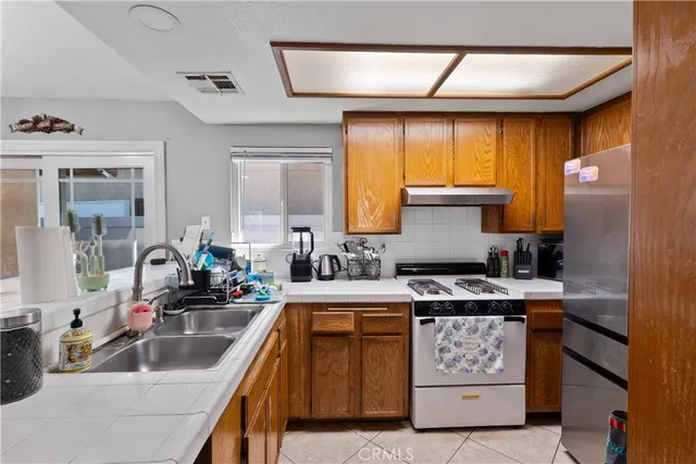 a kitchen with a stove a sink and a refrigerator