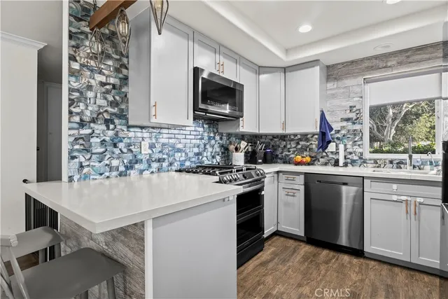 a kitchen with a sink cabinets and window