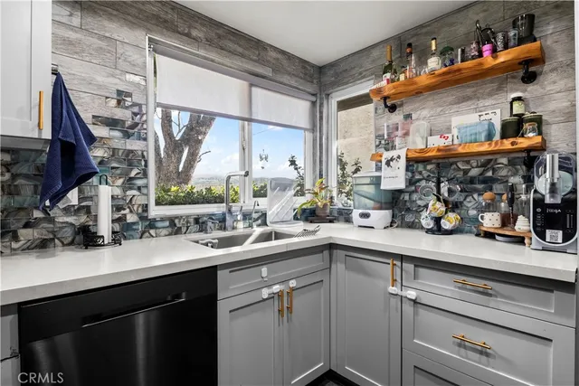 a kitchen with stainless steel appliances a sink and cabinets