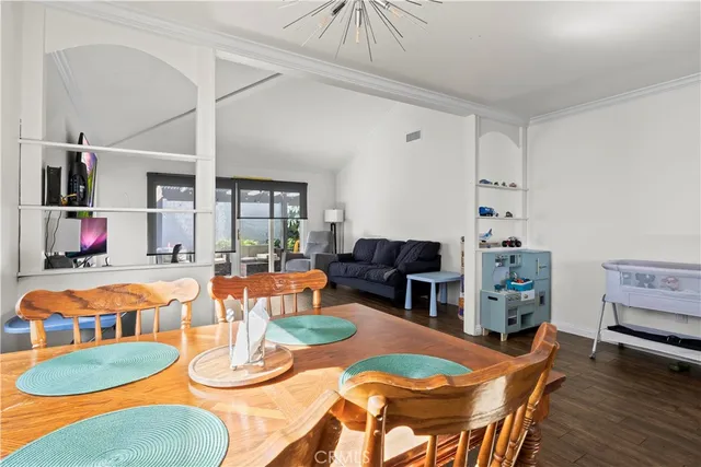 a dining room with furniture and wooden floor