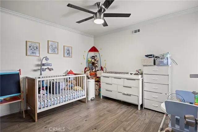a view of a bedroom with furniture and wooden floor